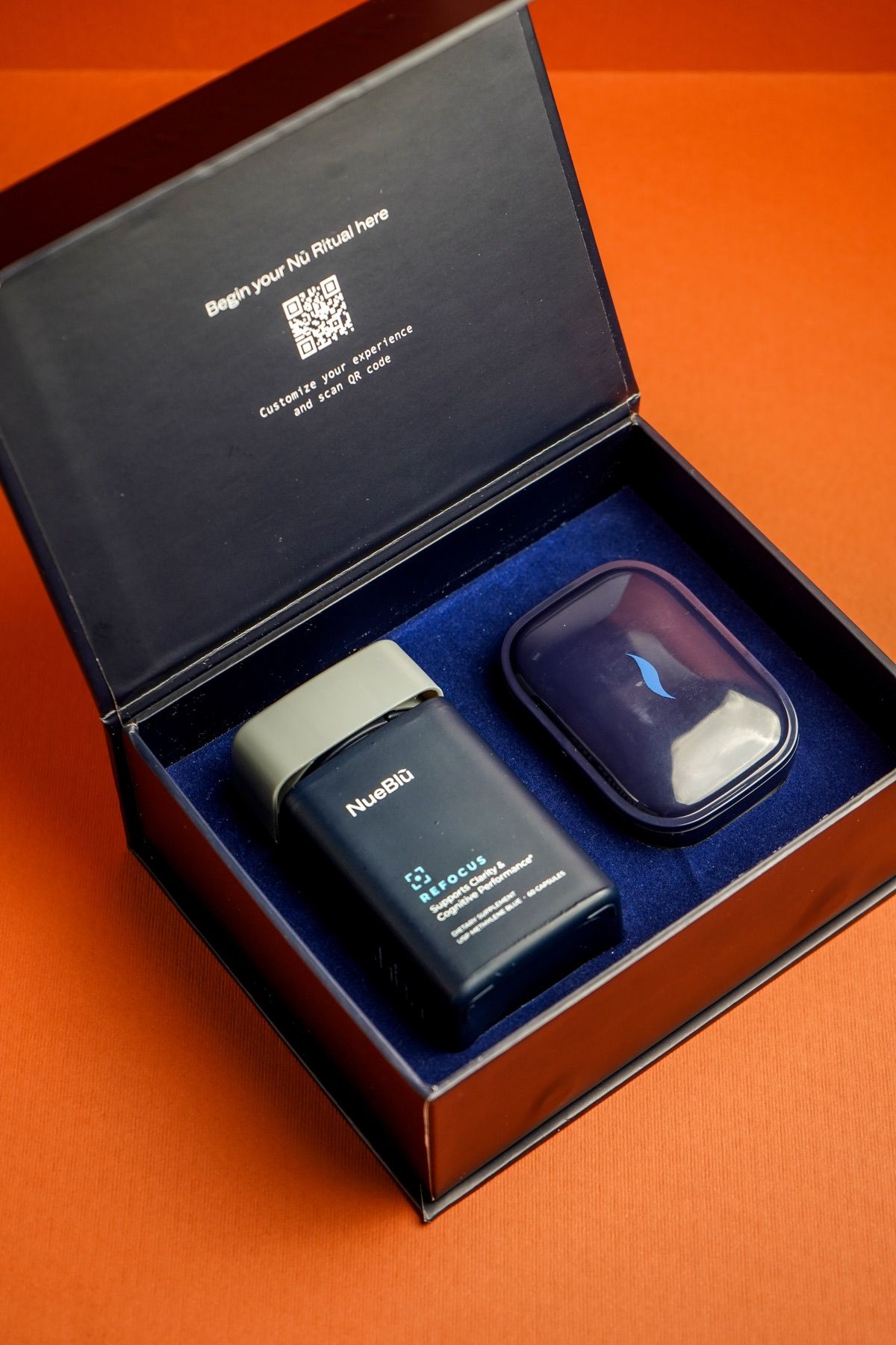 An open NueBlū gift box with a jar and pocket pill case
